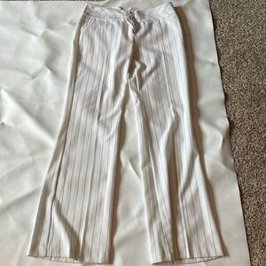 BCX woman’s white trousers with black pinstripes down the pants.